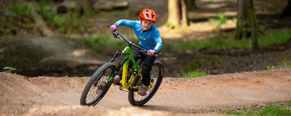 Kids having serious fun riding mountain bikes off road