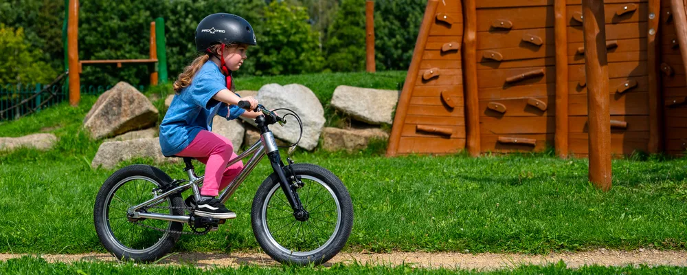 girl rides 12 inch Marin bike in the park