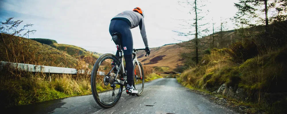 man cycling on a winter day wearing leg warmers in the welsh hills