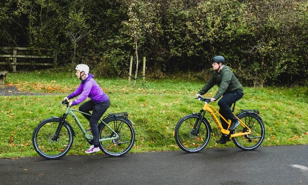 Two cyclists on Orbea e-bikes enjoying an autumn ride