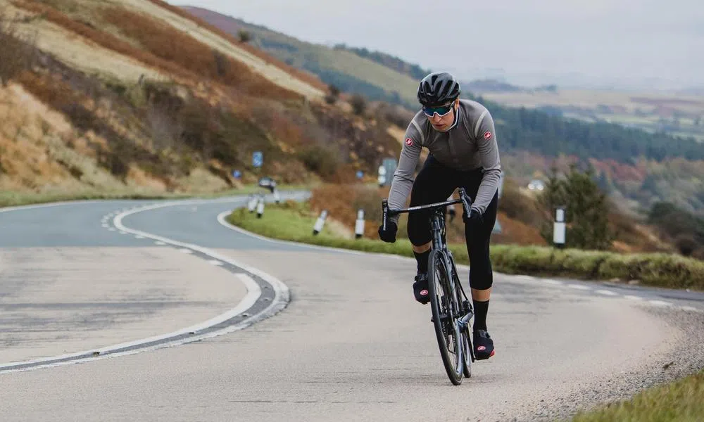 cyclist riding winding road