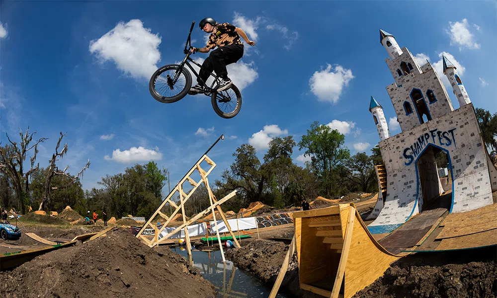 a BMX bike rider jumps through the air