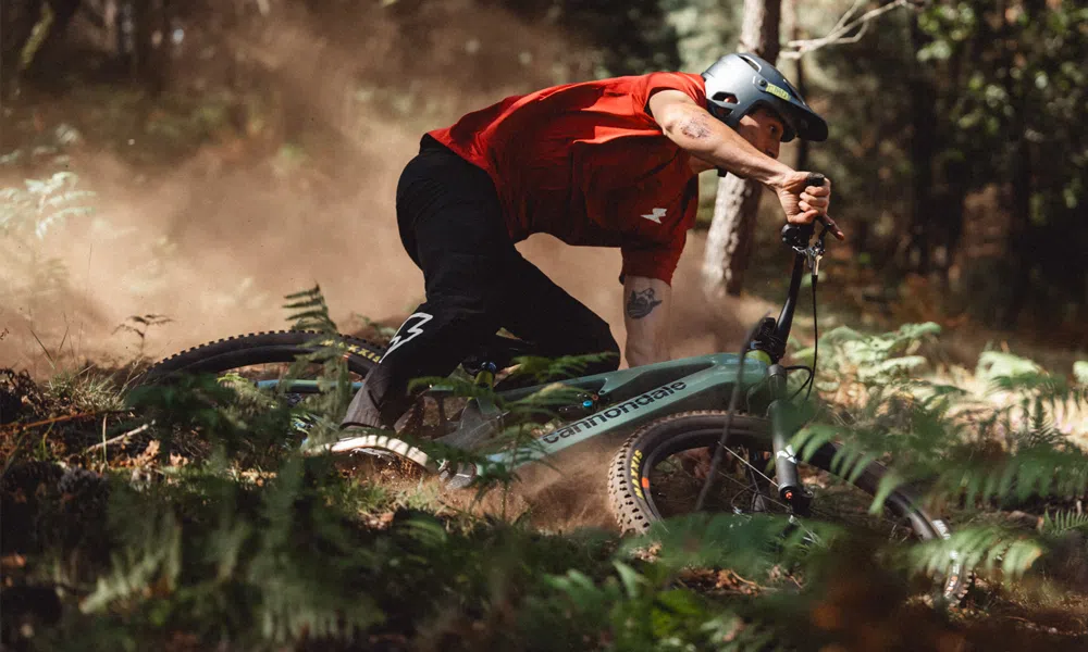 A mountain biker riding a Cannondale Moterra eMTB