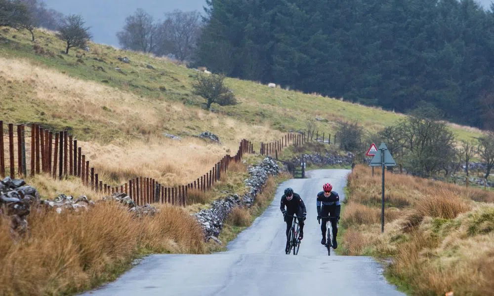 road riders climbing a hill