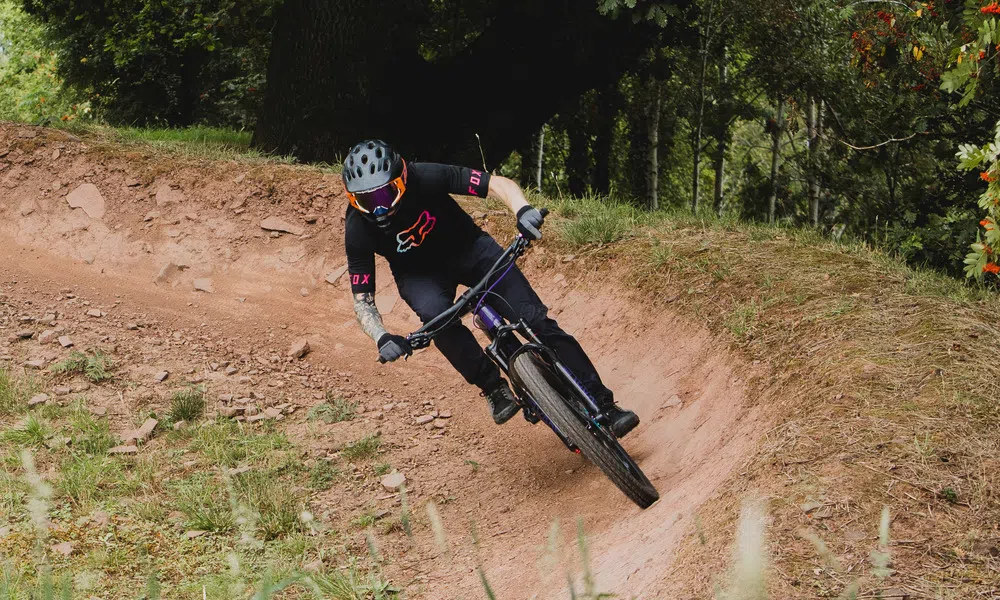 rider on dusty mountain bike trail 