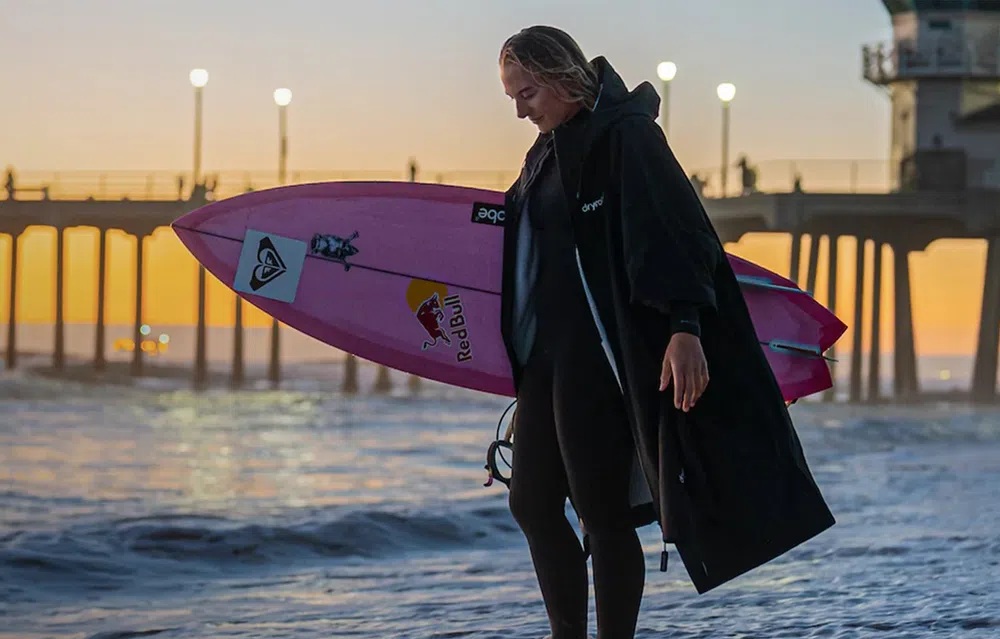 surfer standing in a dryrobe