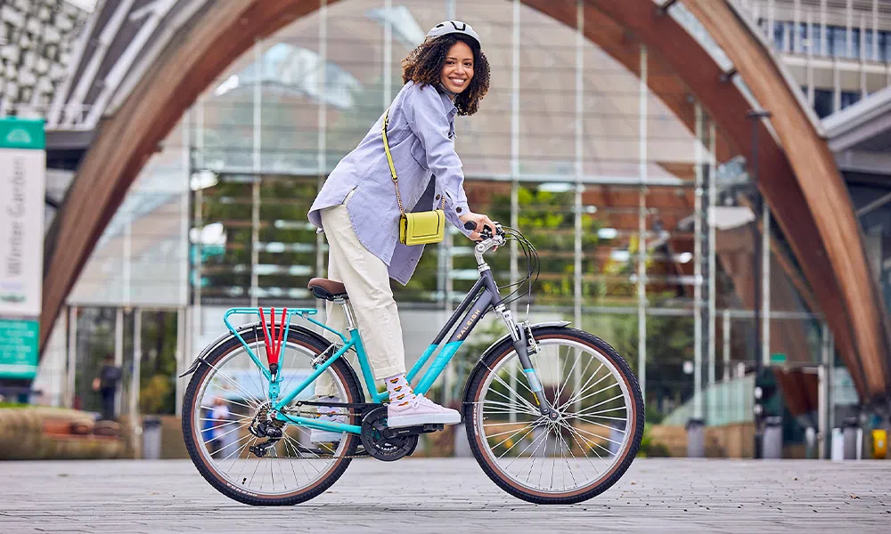 woman riding a hybrid classic bike in the city