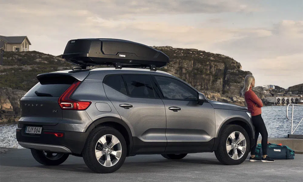 a roof box on an suv near the water