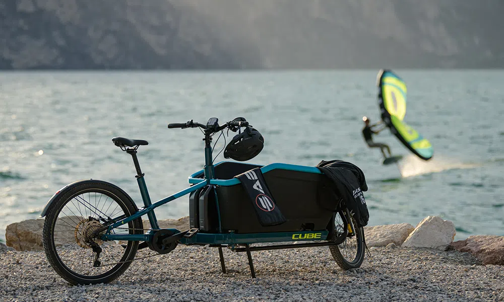 An electric cargo bike by the side of a lake