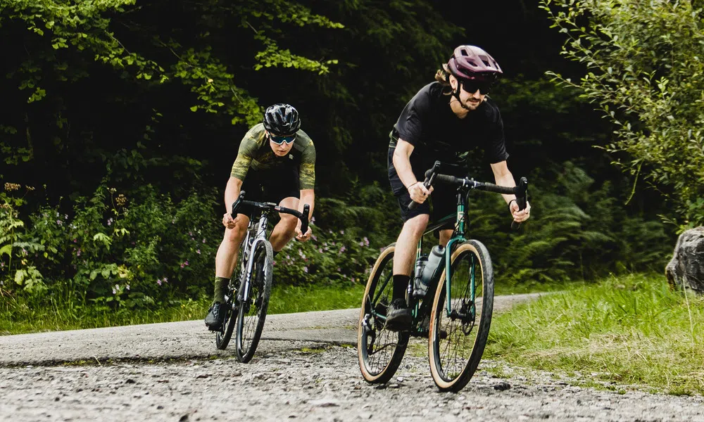 two gravel cyclists riding a loose gravel corner