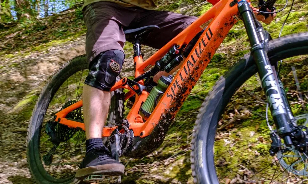 close up electric mountain bike rider with knee pads