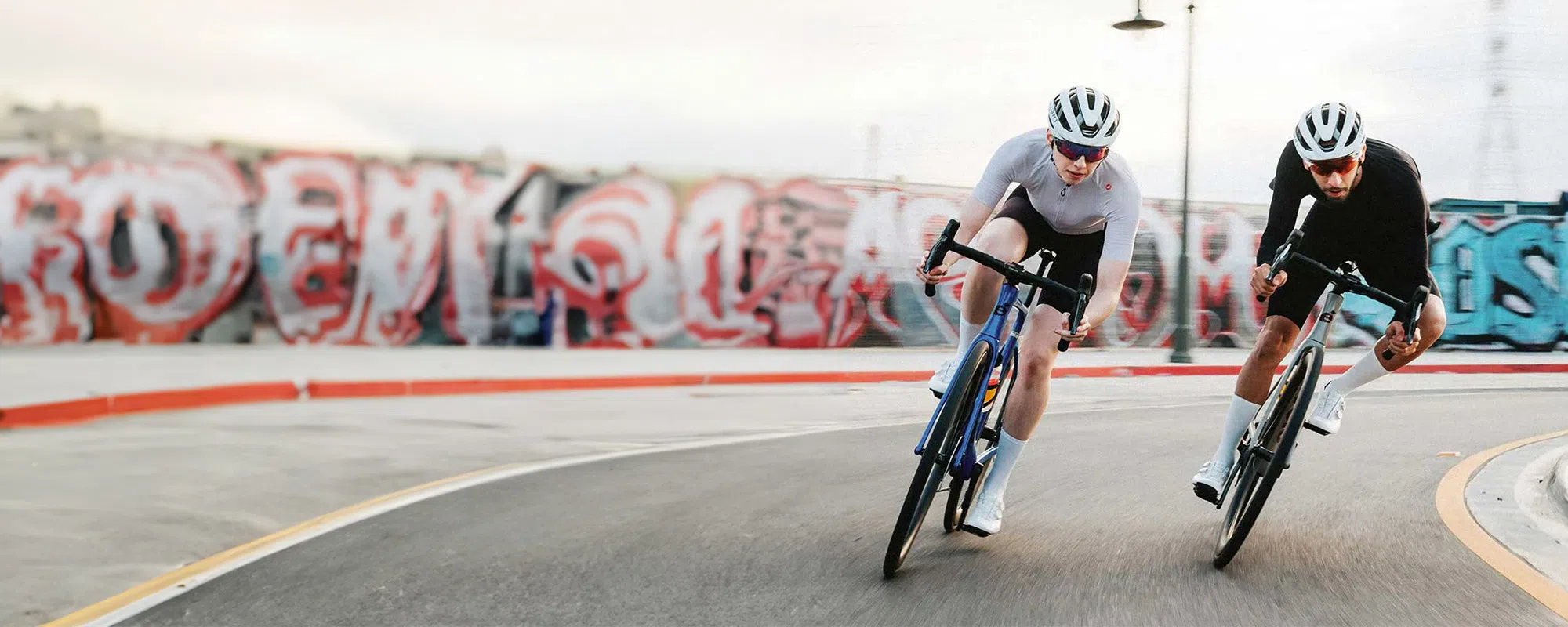 two cyclists riding Cervelo bikes on urban roads