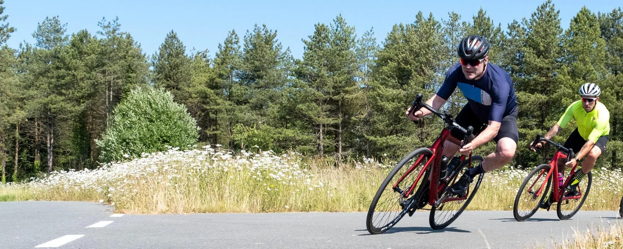 two road cyclists cornering in giro helmets