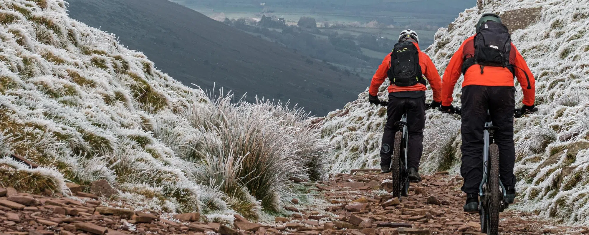 Mountain bikers descending on a crisp frosty winter day