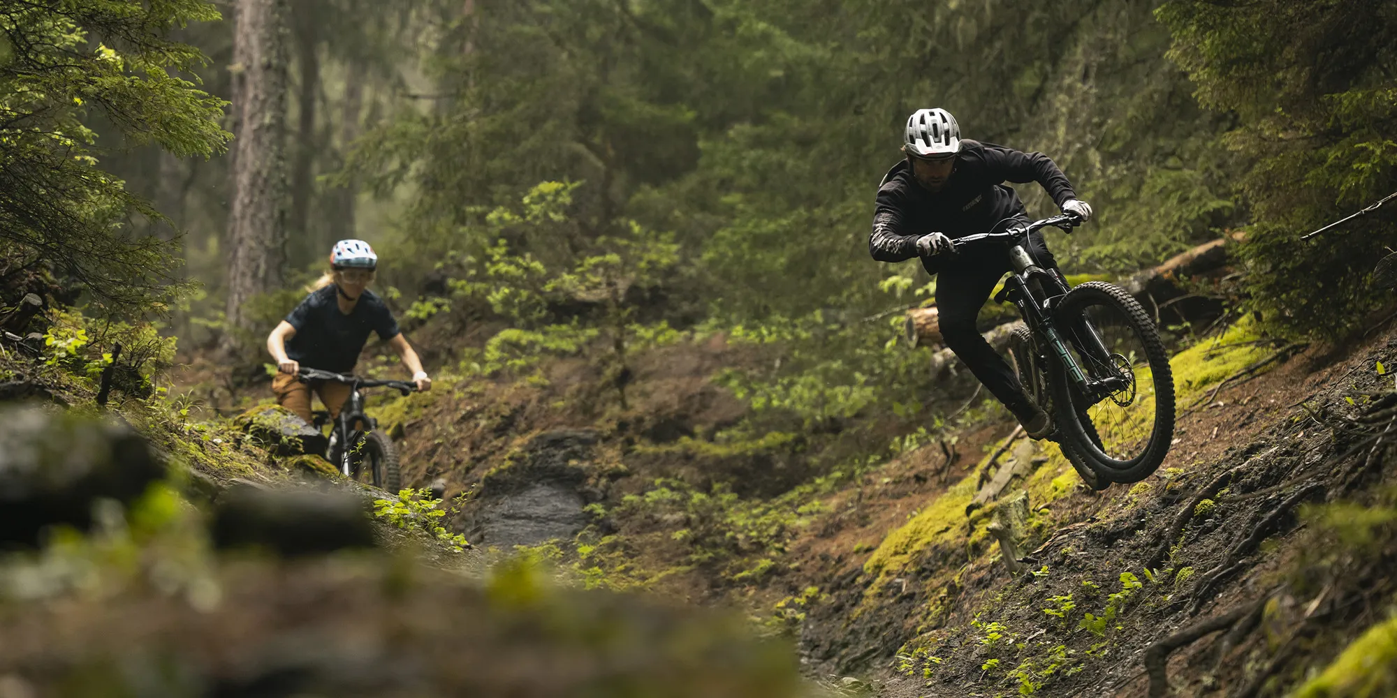 Two mountain bike riders shredding in the woods on Trek MTBs