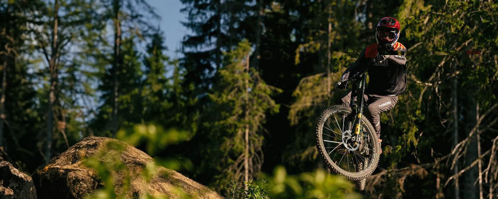 mountain biker getting air in the woods