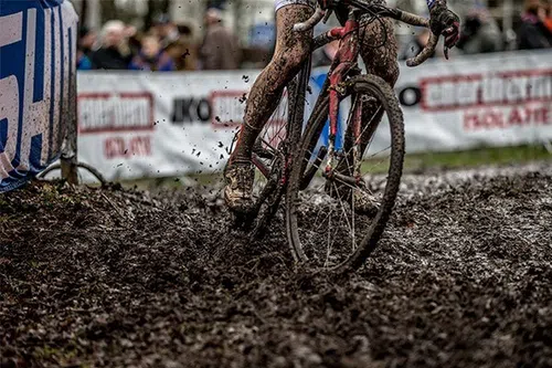 riding a cyclocross bike on a very muddy race course