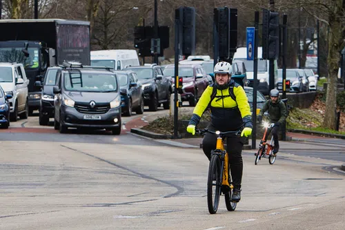 cyclists riding in busy traffic in the city