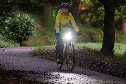 riding a bike through the park at night with lights