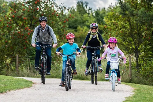 family cycling together