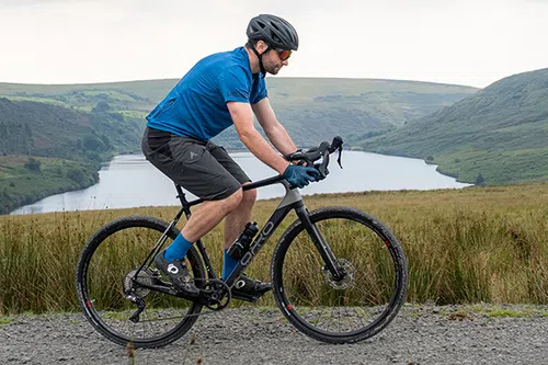 riding a gravel bike past a lake