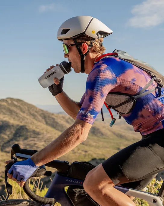 Gravel Race cyclist drinking from a Trek water bottle