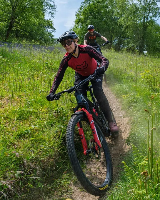 Woman riding a Merida electric mountain bike on a sunny spring day