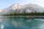 men rowing using a brown boat on a body of water