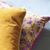 yellow and purple decorative throw pillows 