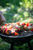 a man making chicken skewers on a bbq campfire 