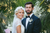 photo of newlyweds with a plant background