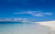 a yacht on an empty sandy beach 