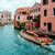 gondolas going under a bridge in venice