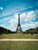 people sitting on grass by the eiffel tower