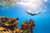 a woman scuba diving in a coral sea 