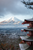 a traditional japanese building facing a snow covered mountain