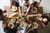 dinner table full of guests having a meal