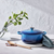 le creuset pot on marble placemat in white kitchen