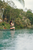 a plank on a river with a lady doing yoga poses on it 