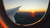 aeroplane window at sunset over a city landscape