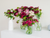 flowers in jars in various shades of pink