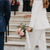 Islington town hall bride wearing white suit and holding a bouquet of pink peonies