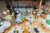 wedding tables with green and white lanterns in a barn