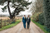 newlyweds carl and marc smiling at each other in a field