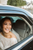 a happy bride in a black car