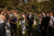 newlyweds walking down the aisle in celebration with white confetti 