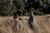 happy couple dancing in forest meadow 