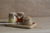 small honeypots next to a pot of seeds on a wooden tray