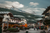 a lit up village with mountains in the background