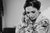 Bride putting on earrings